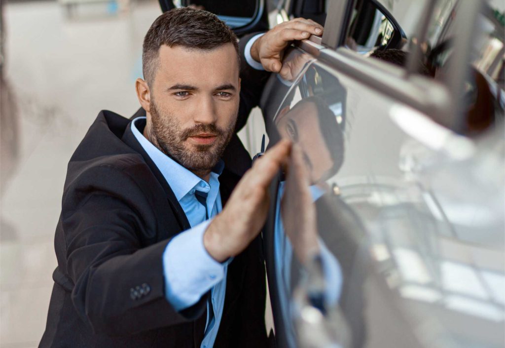 photo of young man touching and checking new car c 2yaebhs